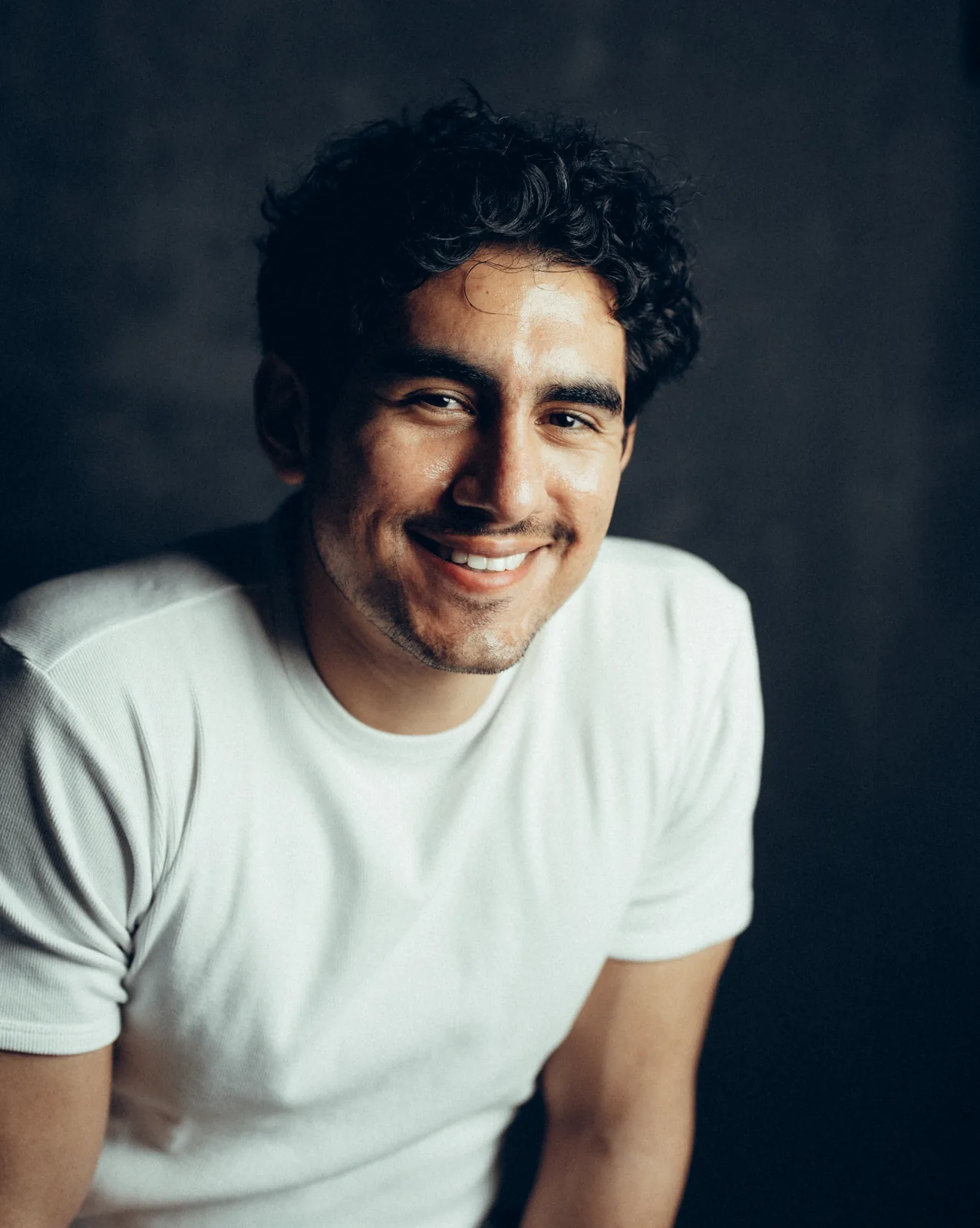 Lenny Ramos close-up portrait, smiling, white t-shirt